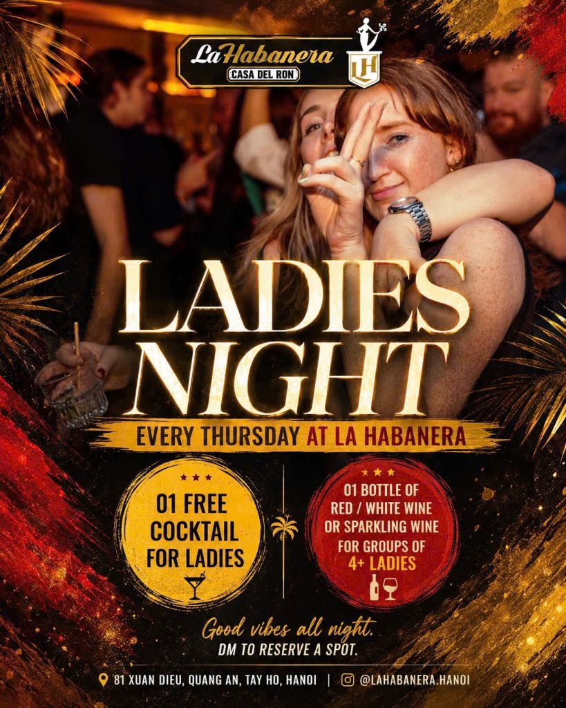 Two women enjoying Ladies Night at La Habanera Casa del Ron in Hanoi with cocktail and wine promotions.